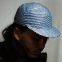 Kaïto is wearing a Le Panache Paris© cap made in France with blue and wihte stripeweave100% cotton.